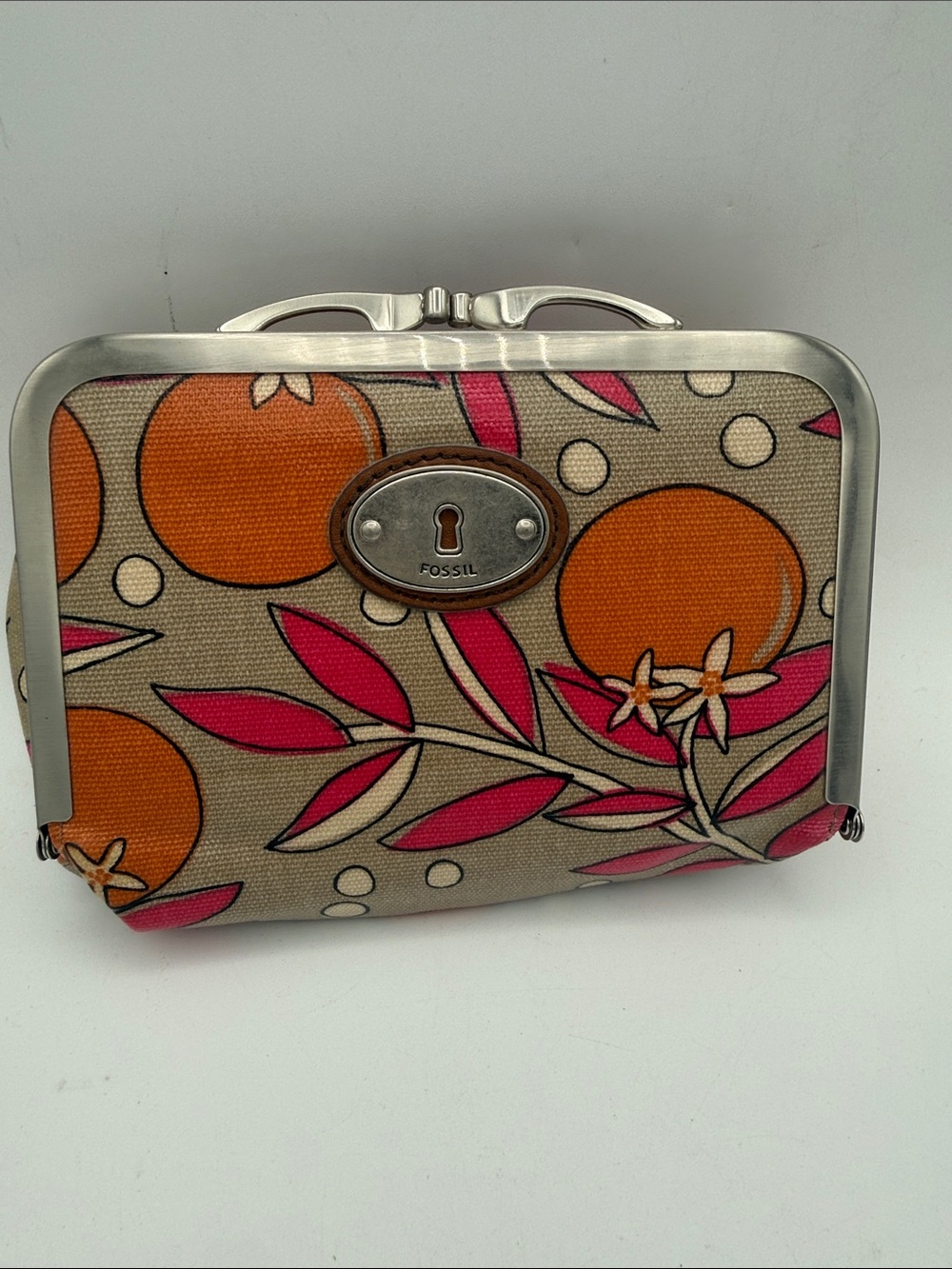 Fossil Key-Per frame cosmetic bag in a tan, orange, pink citrus floral pattern